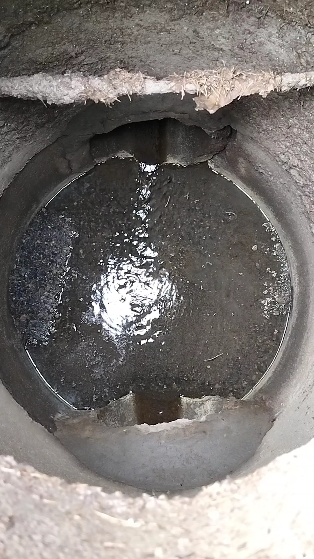 A sewer manhole with open-channel wastewater flow